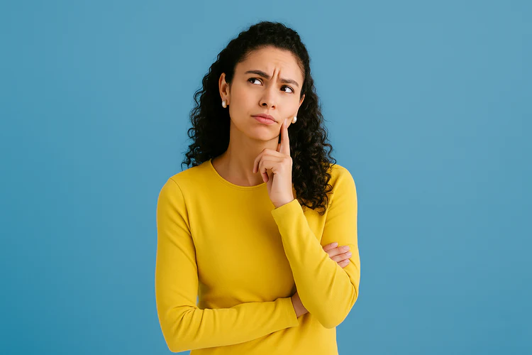 Woman in yellow shirt, thinking